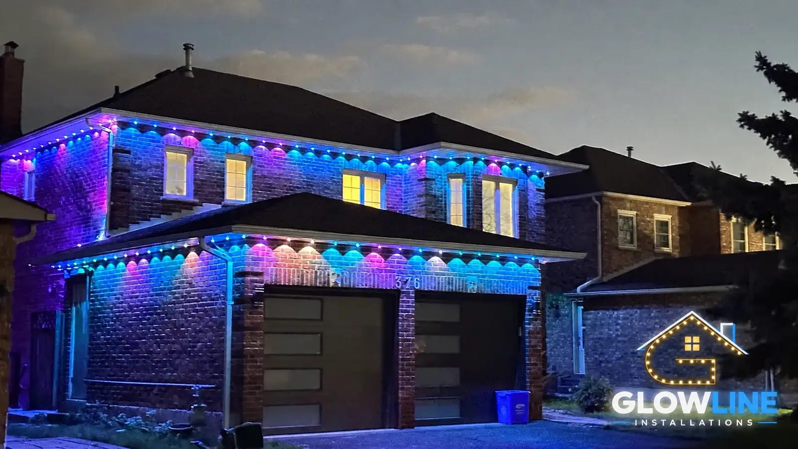 Blue permanent outdoor lights on a Mississauga-style detached home