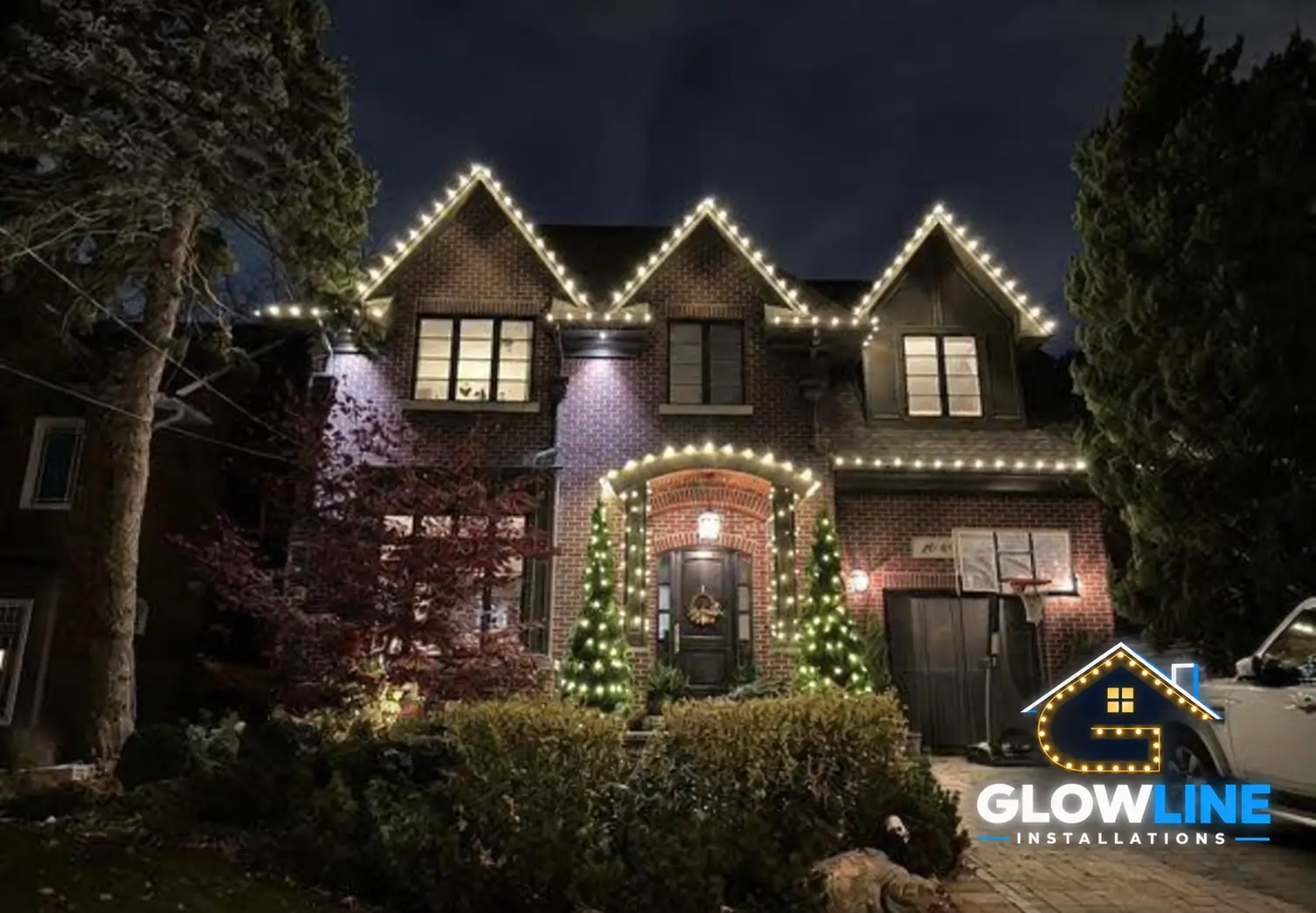 Warm white permanent architectural lights on luxury home