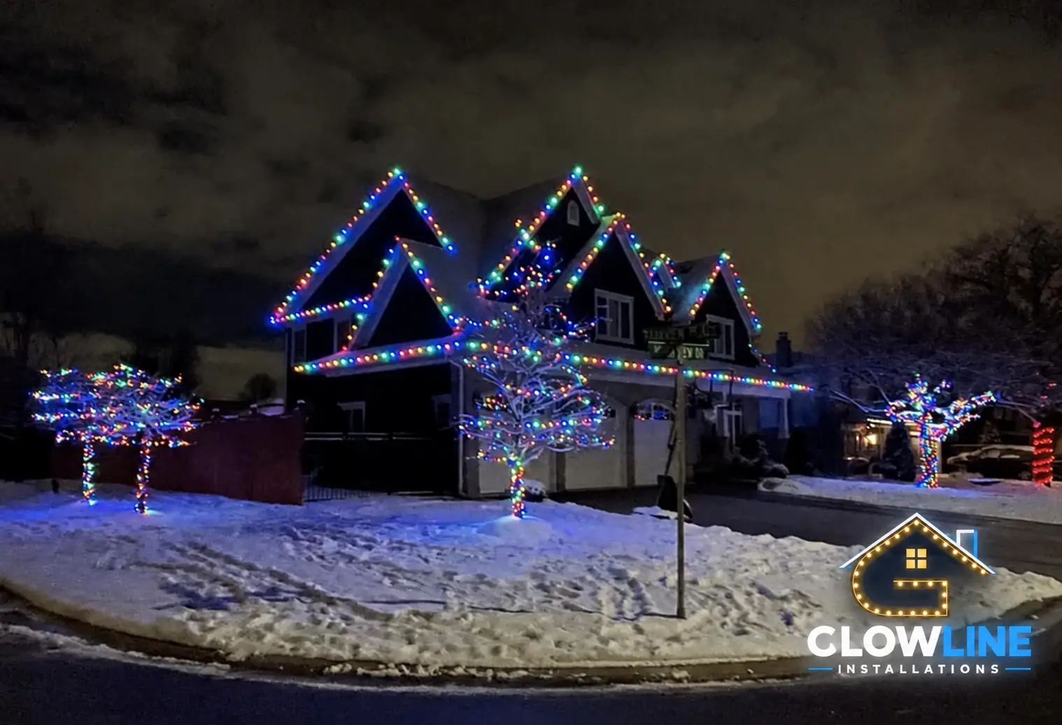 Christmas outdoor lights on a snow-covered house